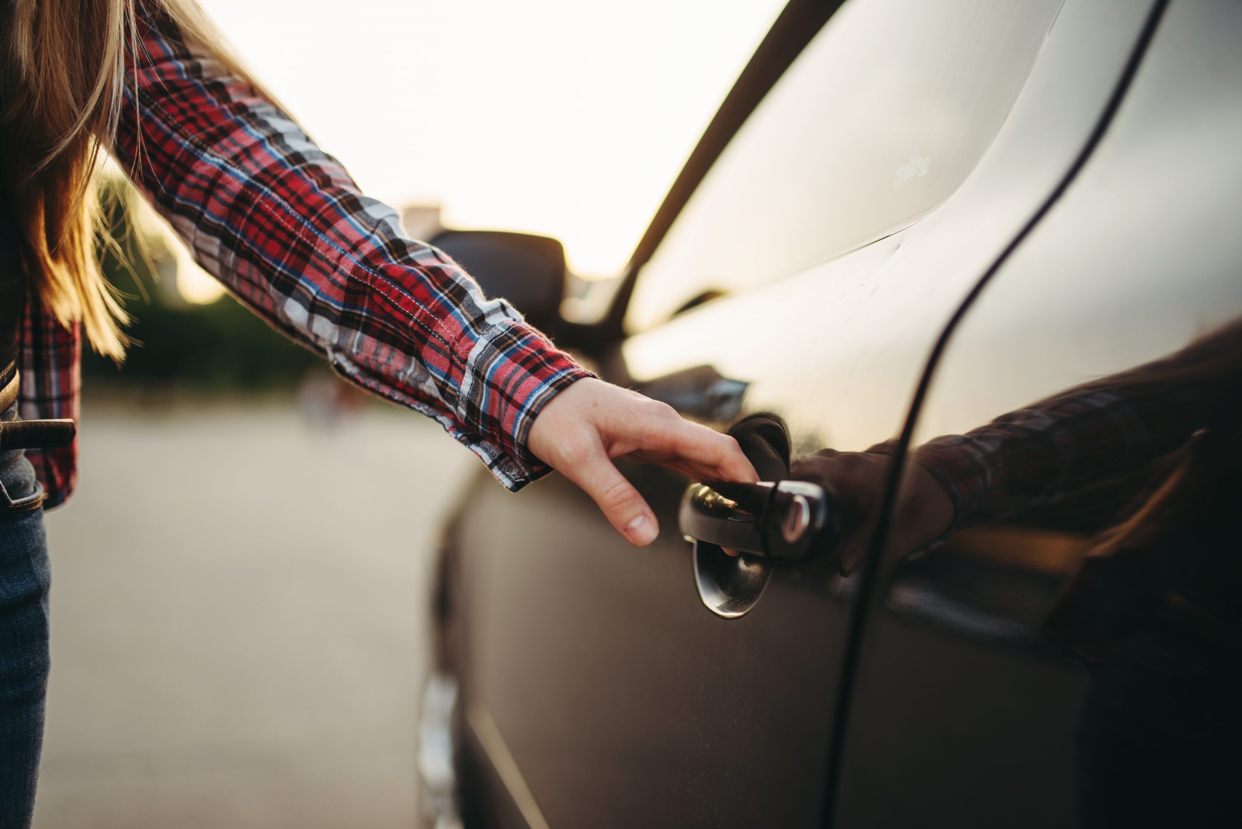 Female hand open car door, driver beginner concept